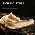 Rich moisturising hand cream texture on black and gold stone