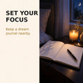Dream journal and candle for setting a bedtime intention as part of a lucid dreaming practice.
