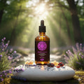 Bottle of Crown Chakra essential oil blend in a natural setting with lavender and sunlight.