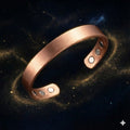 Copper bracelet with embedded stones on a cosmic background