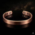 Copper bracelet with embedded stones on a dark background