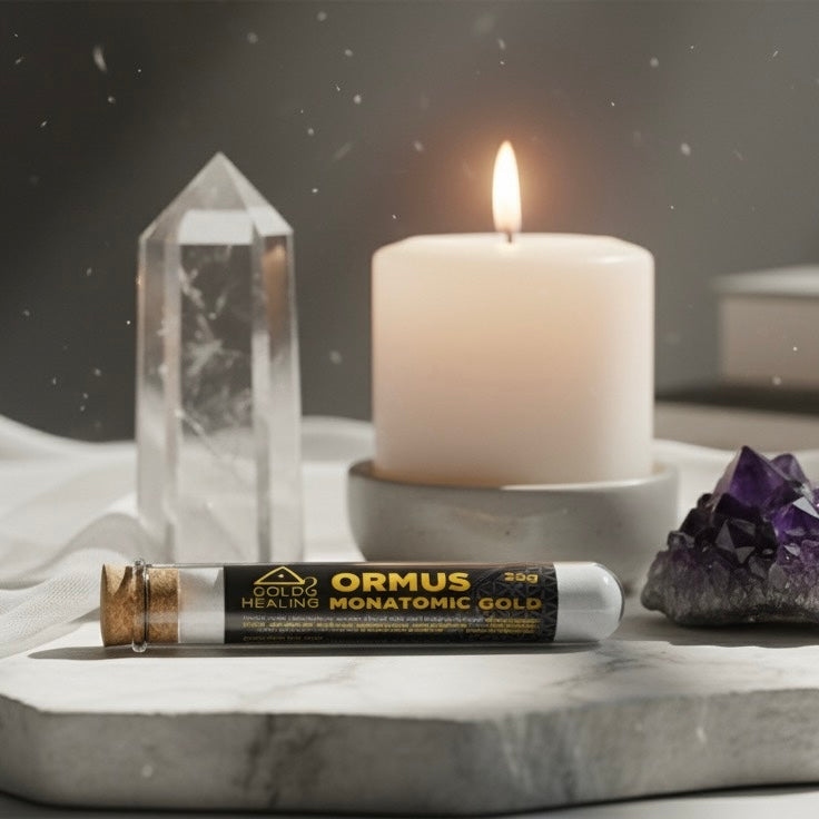  ORMUS Monatomic Gold tube with a candle, crystal, and amethyst on a dark background