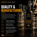 Gold Healing Liquid Ormus Monatomic Gold tincture bottle on a dark reflective surface with laboratory glassware in the background. The bottle is black with gold text and features marketing text about quality, manufacturing, and UK origin.