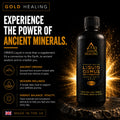 A bottle of Gold Healing Liquid Ormus Monatomic Gold supplement shown on a dark promotional background with glowing gold light effects and text describing its benefits.