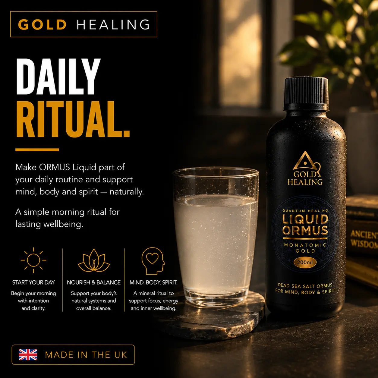 Gold Healing Liquid Ormus Monatomic Gold daily ritual supplement bottle and a glass of cloudy liquid on a dark tabletop with warm background lighting.