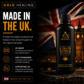 A bottle of Gold Healing Liquid Omrus Monatomic Gold tincture displayed on a stone pedestal against a dark background with a Union Jack and Big Ben. The left side features a black panel with 'MADE IN THE UK.