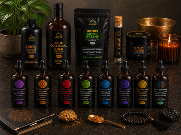 Gold Healing wellness product collection featuring liquid Ormus, colloidal gold, chakra tinctures, nootropic mushroom blend, skincare cream and Ormus Super Greens on a luxury dark background