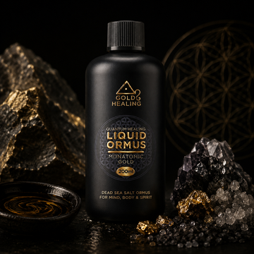 Liquid ORMUS Monatomic Gold bottle photographed in a dark luxury studio environment with mineral crystals and gold accents.
