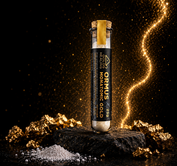 Monatomic Gold Powder UK in glass vial with white mineral powder and Dead Sea mineral source background