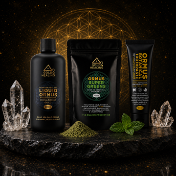 Gold Healing ORMUS collection featuring Liquid ORMUS, ORMUS SuperGreens and Ormus Botanical Toothpaste displayed on a black stone platform with crystals and mint leaves.