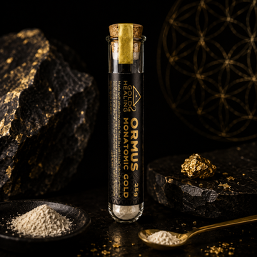 ORMUS Monatomic Gold powder vial presented in a cinematic black and gold setting with mineral powder and alchemical styling.
